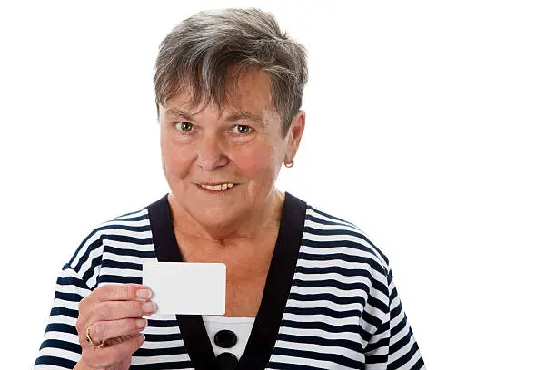 Senior woman showing an white businesscard - isolated