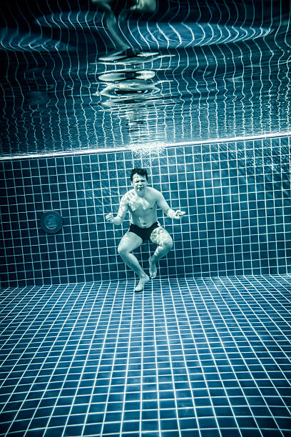 istock Persons standing under water in a swimming pool 485167318