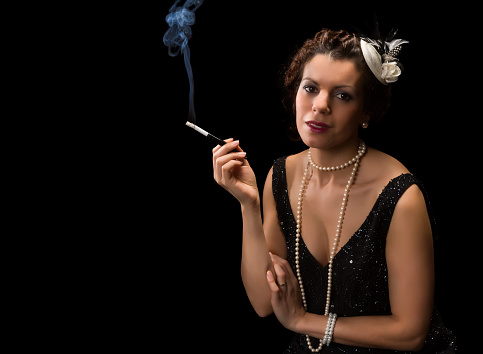 Vintage 1920s lady smoking a cigarette with a mouthpiece