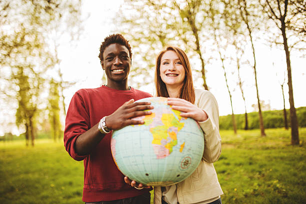 istock teenagers college student smiling with globe 485168311