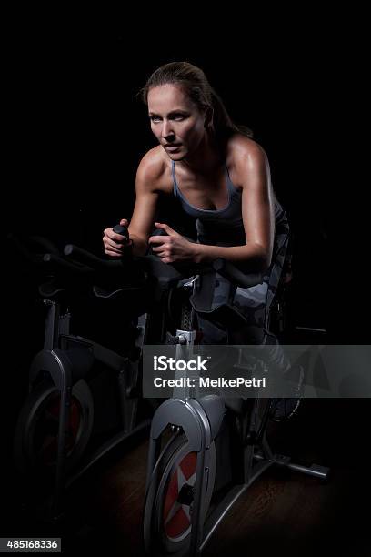 Female Athlete Cycling In Gym Stock Photo - Download Image Now - Health Club, Gym, Cycling