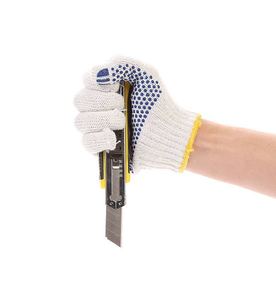 istock Hand holds yellow stationery knife. 485168653