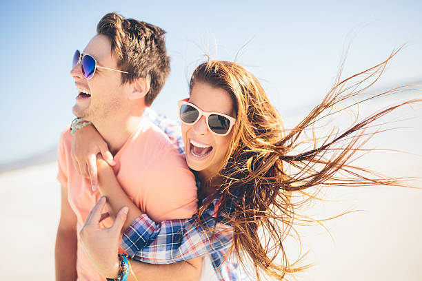 istock Couple piggyback on beach 485169257