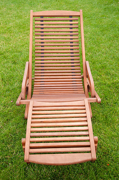 istock Wooden sunbed on green grass 485169443