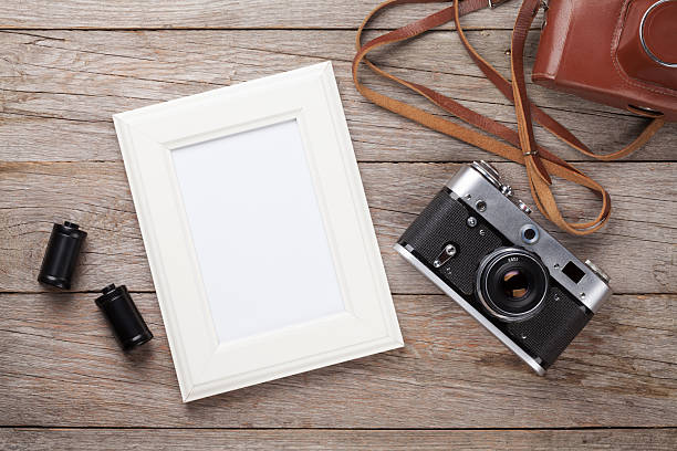 istock Vintage film camera and blank photo frame 485171514