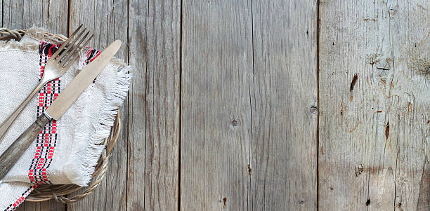 istock Vintage fork and knife on napkin on old wood 485171888