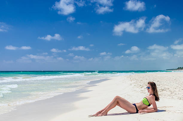 istock Young cute woman lying and getting sun on tropical beach 485178860