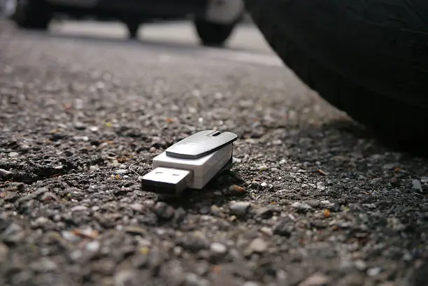 Photo of data loss, data breach. usb dropped on street