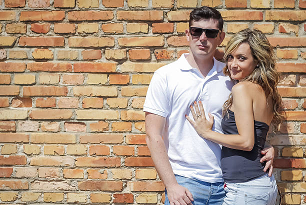 istock Couple portrait in front of brick wall 485191729