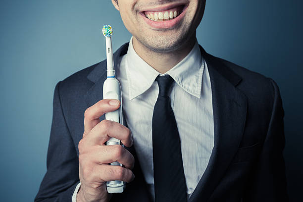 empresario cepillar los dientes - dental hygiene elegance black toothbrush fotografías e imágenes de stock