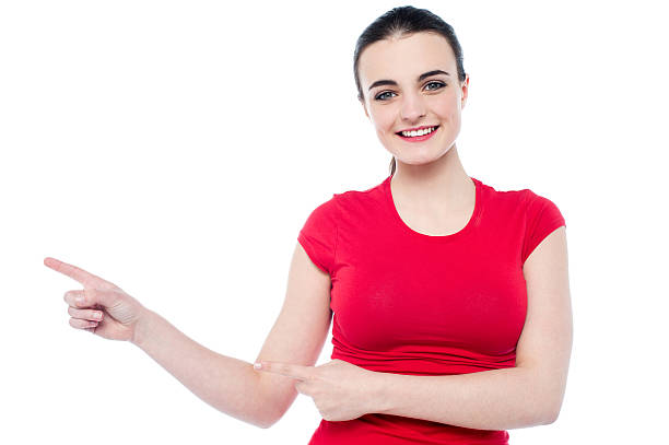 istock Smiling young woman pointing to her right 485192781