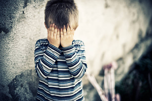 Depressed child Depressed child. Fine noise applied. face down stock pictures, royalty-free photos & images