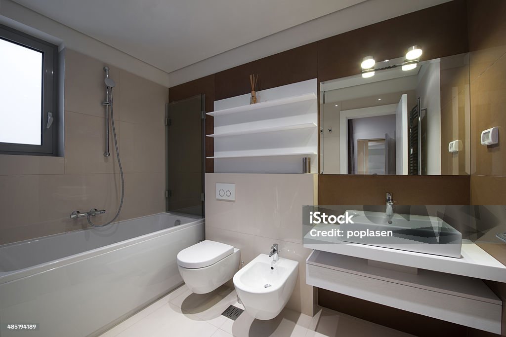 Modern Bathroom Interior of bathroom with brown tiles, bathtub, sink and other items Abstract Stock Photo