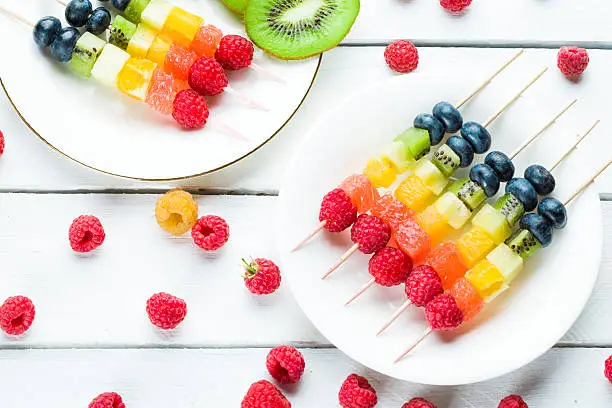 Fresh summer fruits on sticks. Studio shot