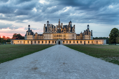 Chambord, France - August 18, 2015: Panoramic view of Chambord Castle at sunset. Built as a hunting lodge for King Francois I, between 1519 and 1539, this castle is the largest and most frequented of the Loire Valley.