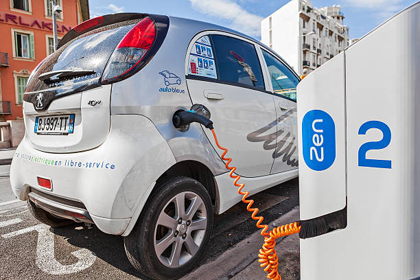 Electric car recharging at station. stock photo