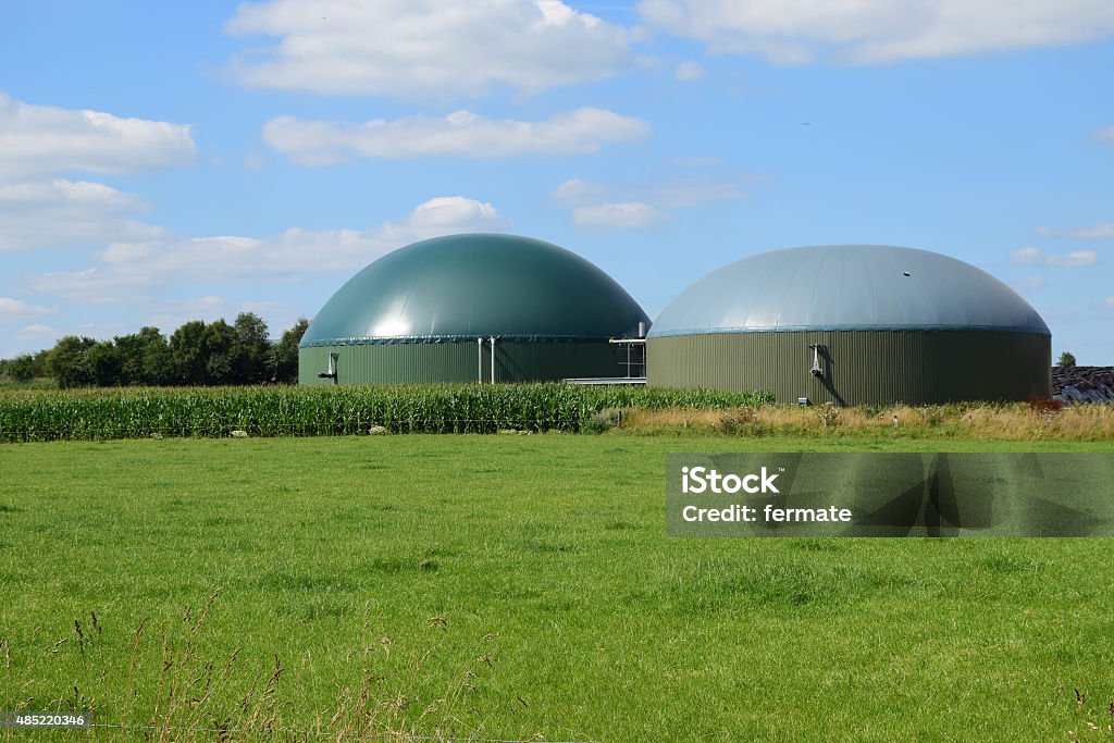 bio gas plant, renewable Resources for renewable energy biogas plant for renewable energy on a green meadow against the blue sky with clouds Biogas Stock Photo