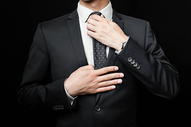 istock man in suit on a black background 485220462