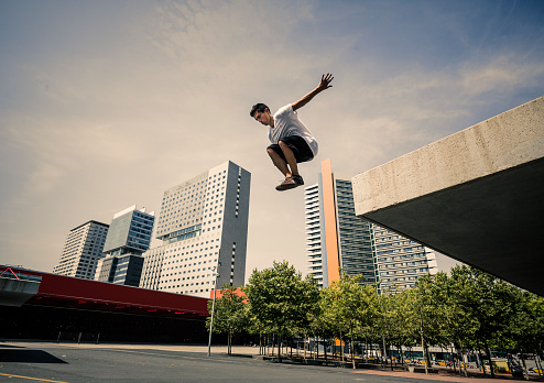 Young man practicing parkour in the city of Barcelona