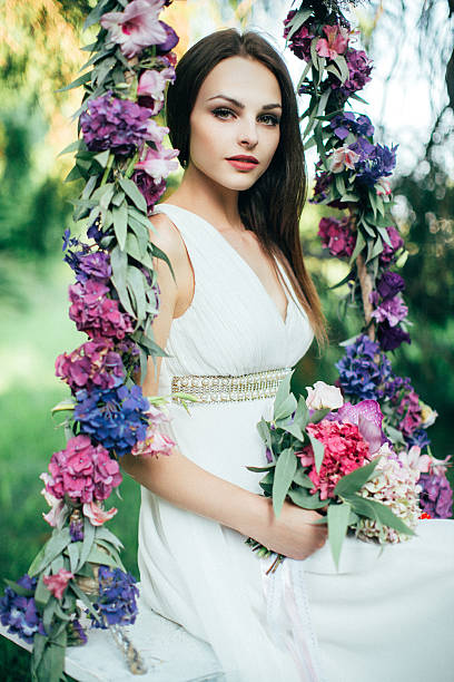 istock Beautiful young girl on a swing 485220732