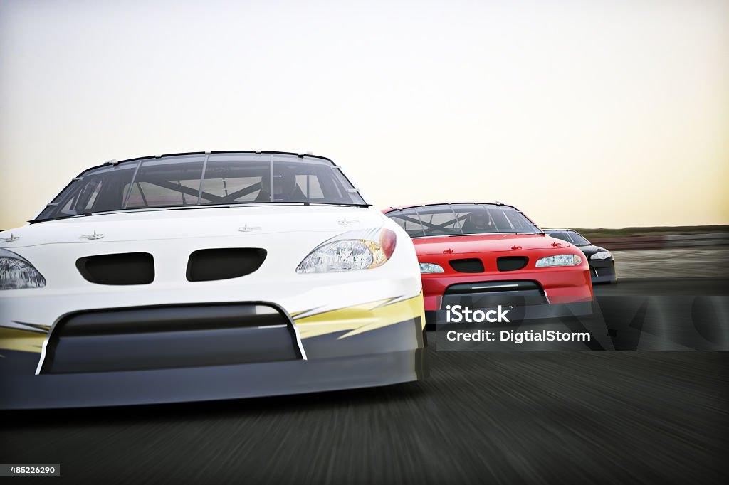 Motor sports racing Front view of auto racing race cars racing on a track with motion blur.  Stock Car Stock Photo