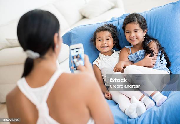 Mother Taking A Picture To Her Daughters Stock Photo - Download Image Now - 2015, 30-39 Years, Adult