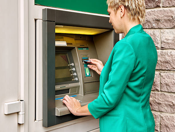 istock Business woman operates ATM 485230630