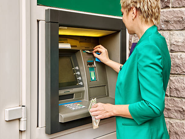 istock Business woman operates ATM 485230638
