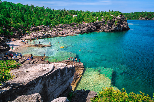 gorgeous amazing stunning  view of lake Huron rocky beach landscape with people in background  