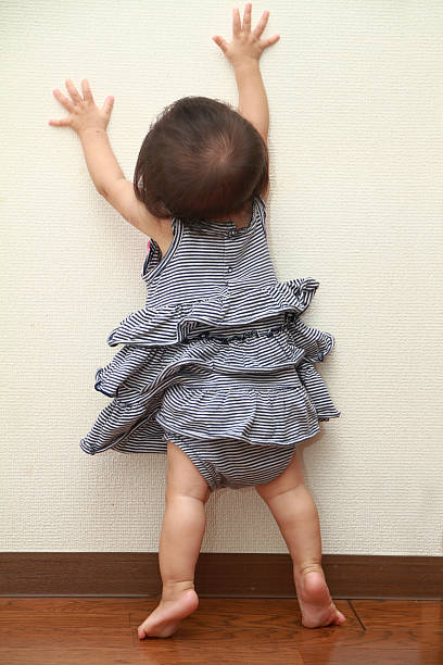 istock Japanese baby girl pulling up to standing 485235448