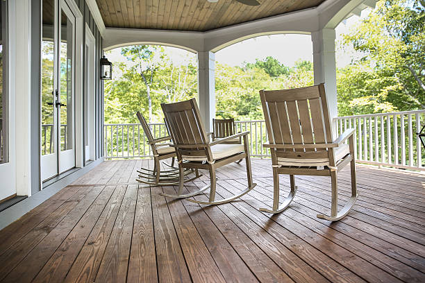 Rocking Chairs on a Southern Porch Rocking chairs grace a upper porch in a large lake front home in the Southern USA. south stock pictures, royalty-free photos & images
