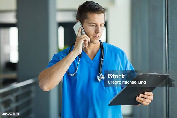Medical Doctor Talking On Mobile Phone Stock Photo - Download Image Now - Telephone, Nurse, Medical Student