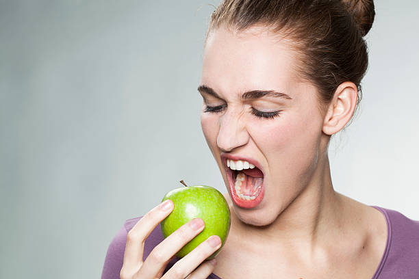 istock hungry 20s girl biting an apple with appetite and thirst 485246102