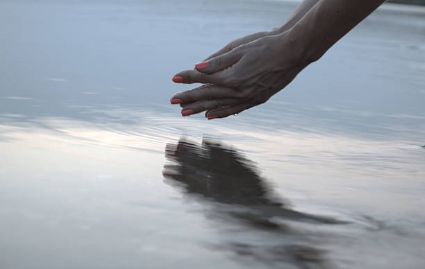 istock Woman hands touching water 485249172