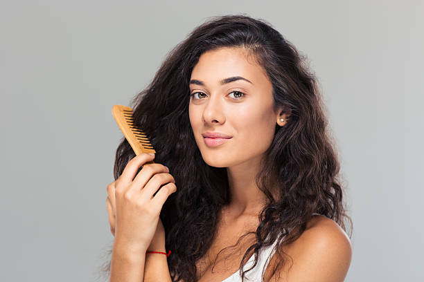 istock Happy cute woman combing her hair 485250502