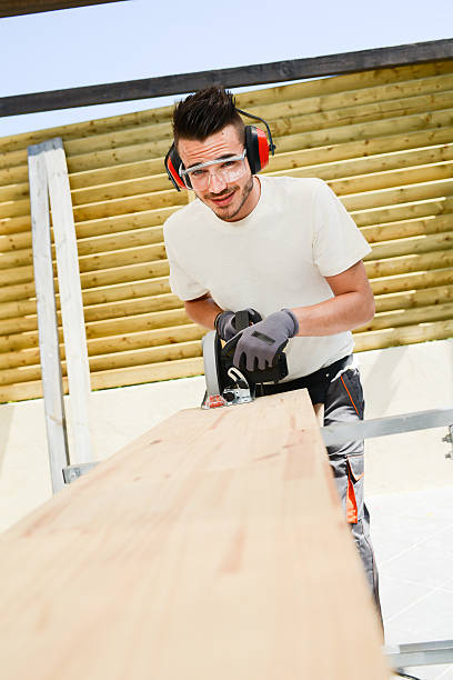 istock young man carpenter working outdoor wood timber in construction site 485251328
