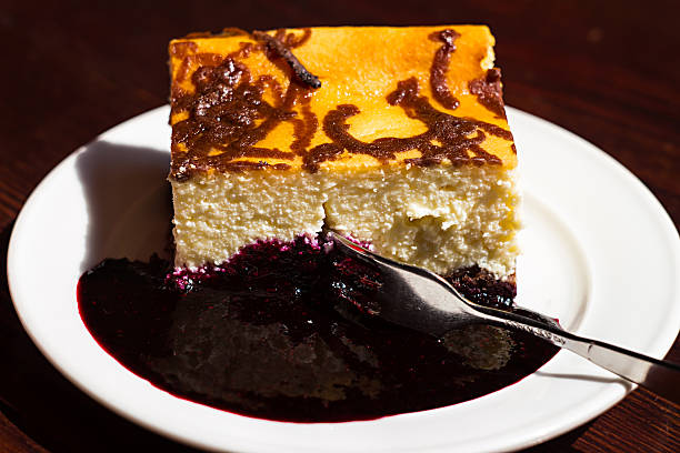 istock Slice cheesecake with blueberry jam on plate,brown table,dessert 485251492