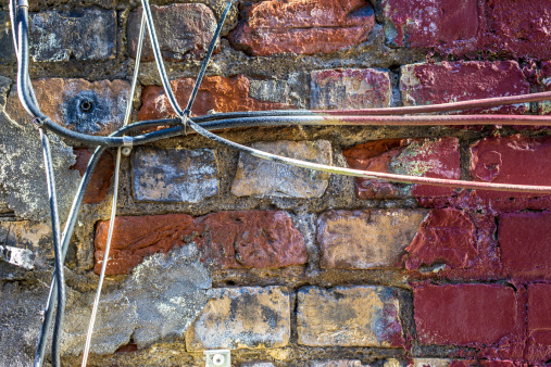 Brick wall and electrical cable.