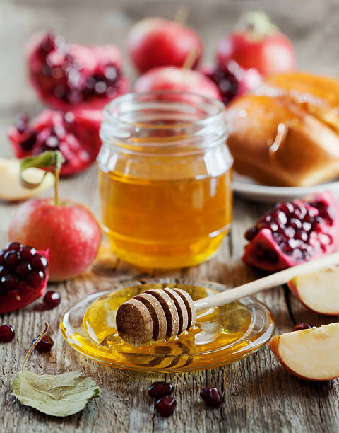 Rosh Hashana, Jewish New Year Holiday, honey, apple, pomegranate, hala Honey, apple, pomegranate and hala, table set with traditional food for Jewish New Year Holiday, Rosh Hashana torah photos stock pictures, royalty-free photos & images