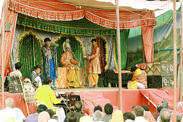 Ramayan - a play on stage Allahabad, India - February 24, 2013: People watching Ramayan play also known as Ram leela during Kumbh mela event in Allahabad, India. prayagraj photos stock pictures, royalty-free photos & images