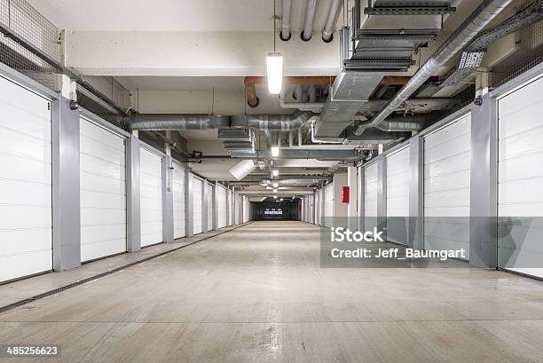 Interior Of Underground Parking Garage In Europe Stock Photo - Download Image Now - Storage Compartment, Parking Lot, Warehouse