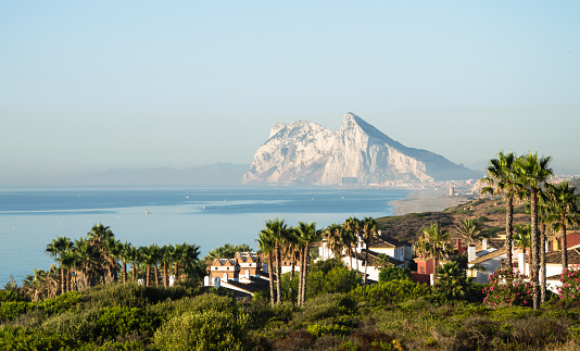 Alcaidesa urbanization in the foreground. Panorama of Straits of Gibraltar. Summer day morning. British overseas territory. Mediterranean sea. 