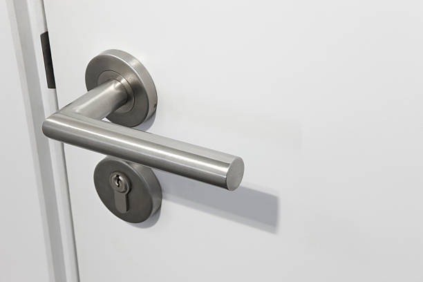 istock Metallic doorknob with lock over a white door 485265364