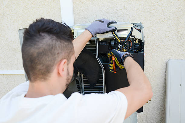 istock handsome young man electrician installing air conditioning in client house 485269678