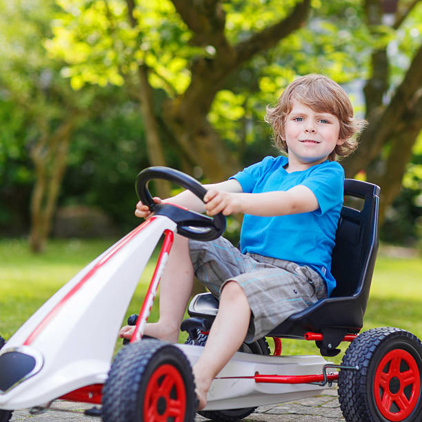 istock Active little boy having fun and driving toy race car 485271882