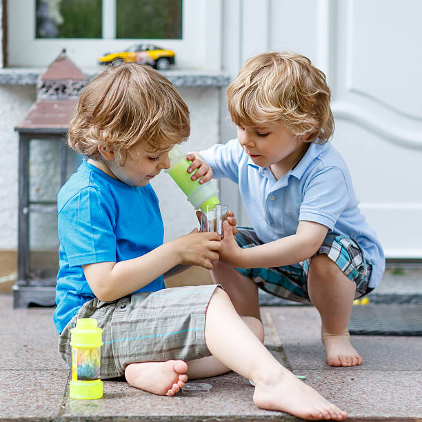 istock Two happy kid boys having fun together outdoors 485271928