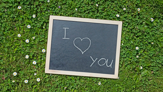 I love you written on a chalkboard in a park