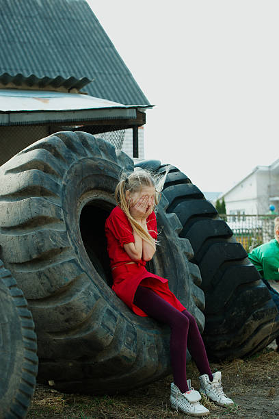 istock girl playing hide and seek in dump 485277396