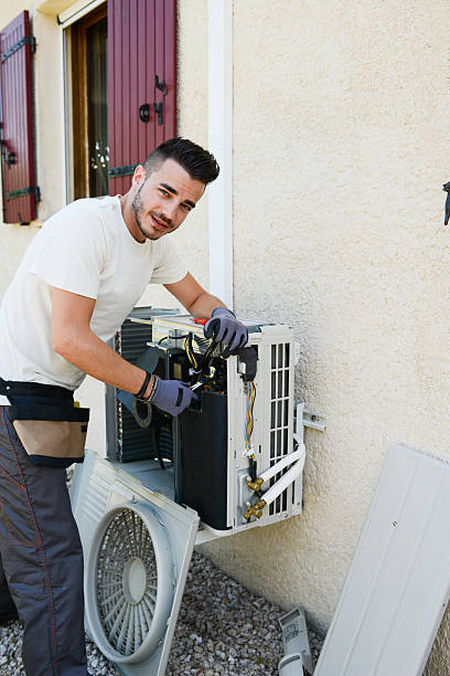 istock handsome young man electrician installing air conditioning in client house 485277514