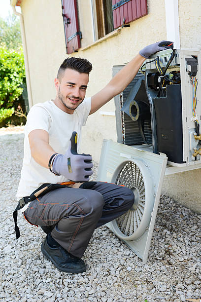istock handsome young man electrician installing air conditioning in client house 485277560
